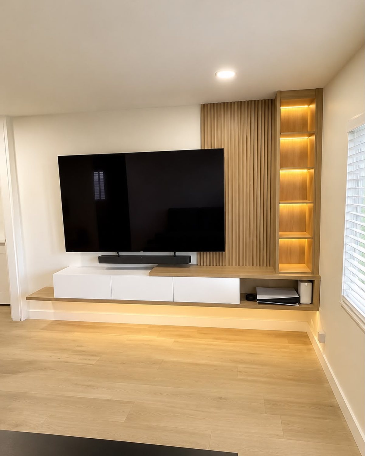 Slatted oak media wall with floating console