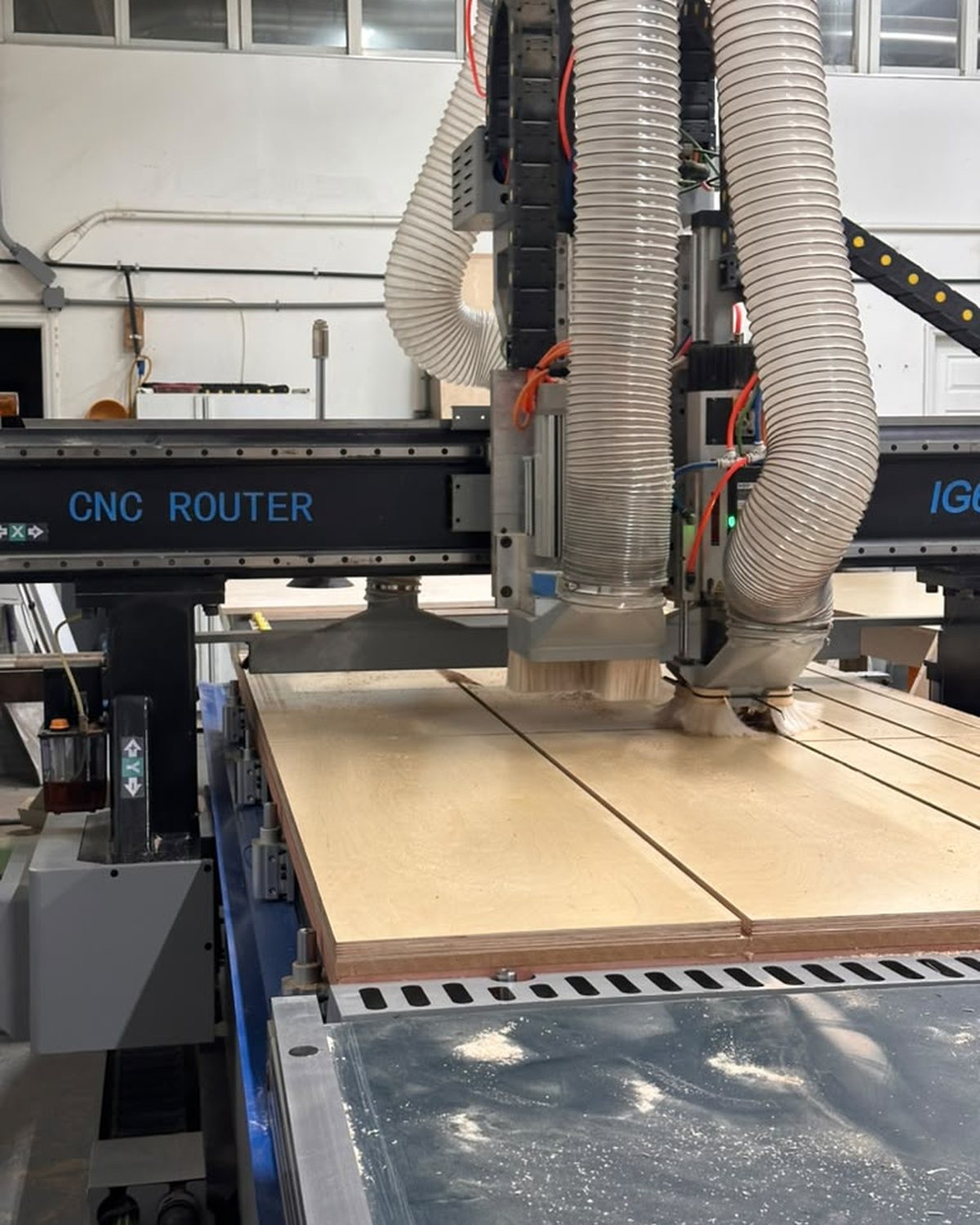 CNC router machining a cabinet panel in-house